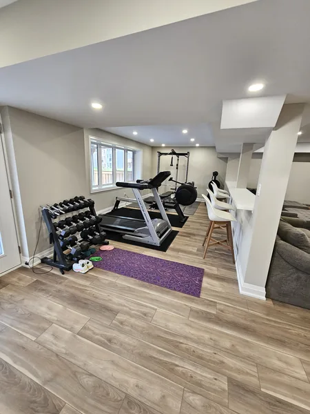Basement home gym Toronto, open to the family room — built in East Gwillimbury