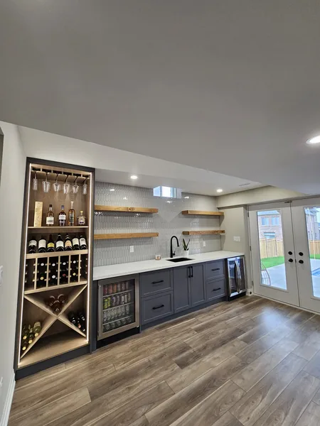 Basement renovation Toronto: the bar's lit wine rack and floating shelves — built in East Gwillimbury