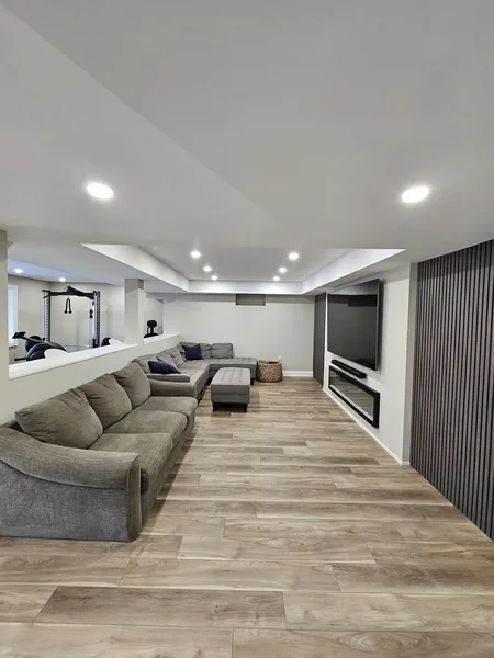 A finished basement in East Gwillimbury: the family room, the sectional and the slat wall