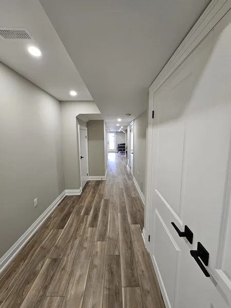 A finished basement in East Gwillimbury: the hallway and its double closet doors
