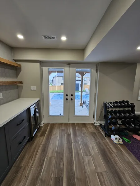 Finished basement Toronto: the walkout French doors beside the bar — built in East Gwillimbury