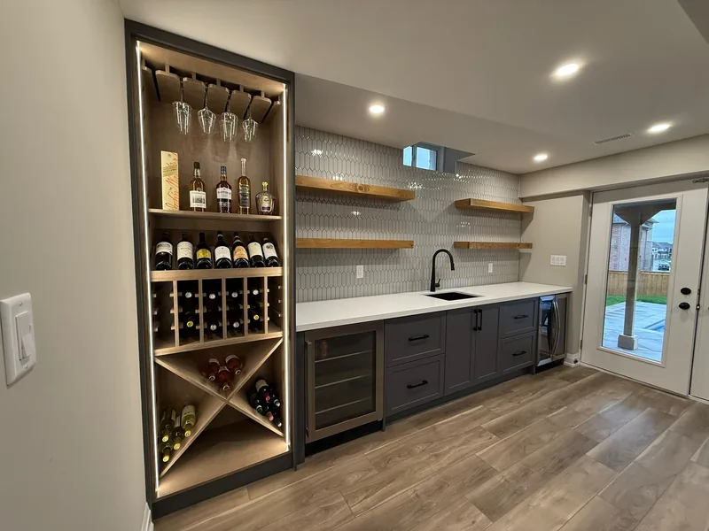 Finished basement Toronto: the wet bar and its lit wine cabinet — built in East Gwillimbury